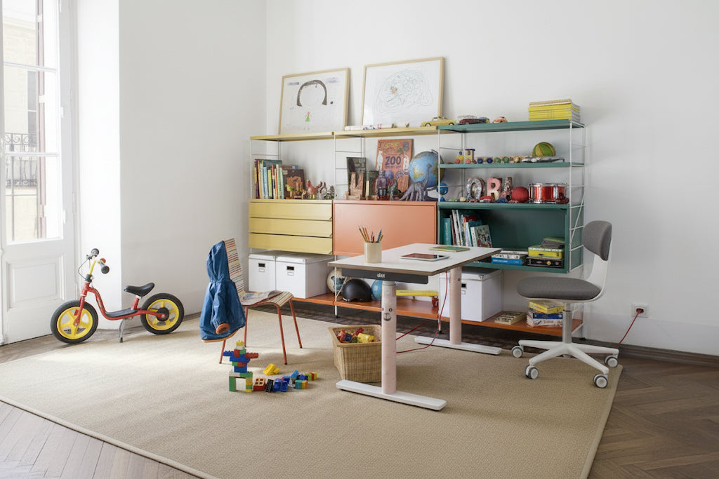 Höhenverstellbarer Kinderschreibtisch Eliot in einem hellen Kinderzimmer mit Spielzeugregal und ergonomischem Stuhl – ideal zum Spielen und Lernen.